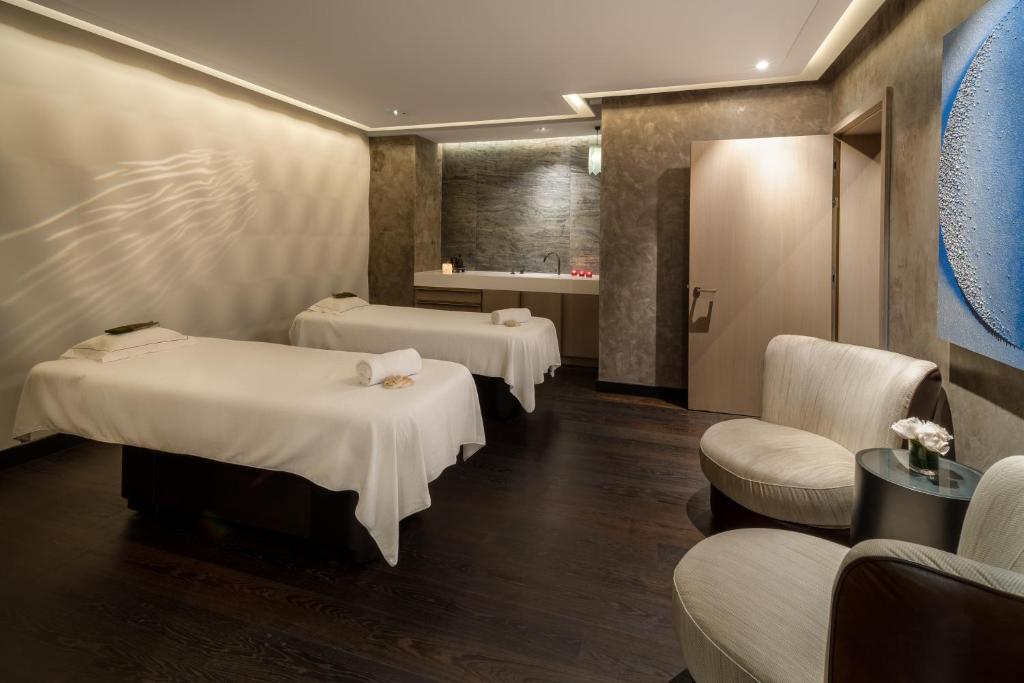 a hospital room with two beds and a waiting area at FIVE Zurich - Luxury City Resort in Zürich