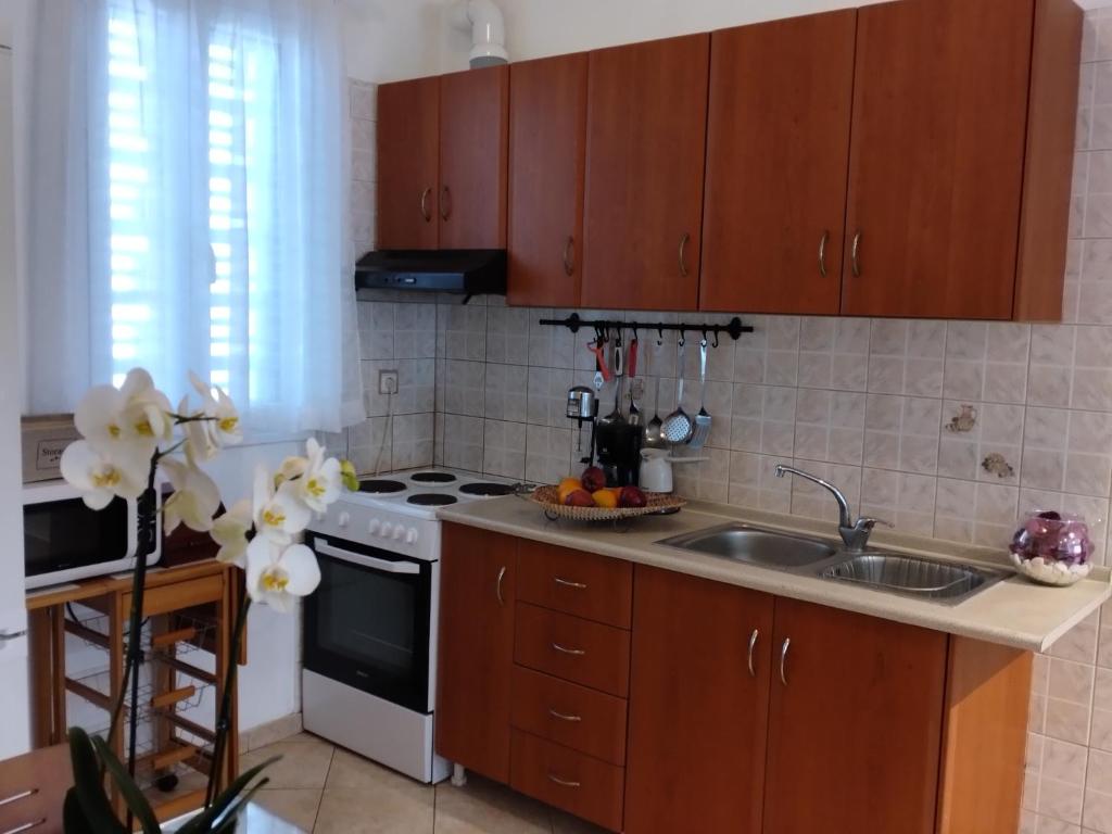 a kitchen with a sink and a stove at Comfy Alykes Apartment, Volos in Volos