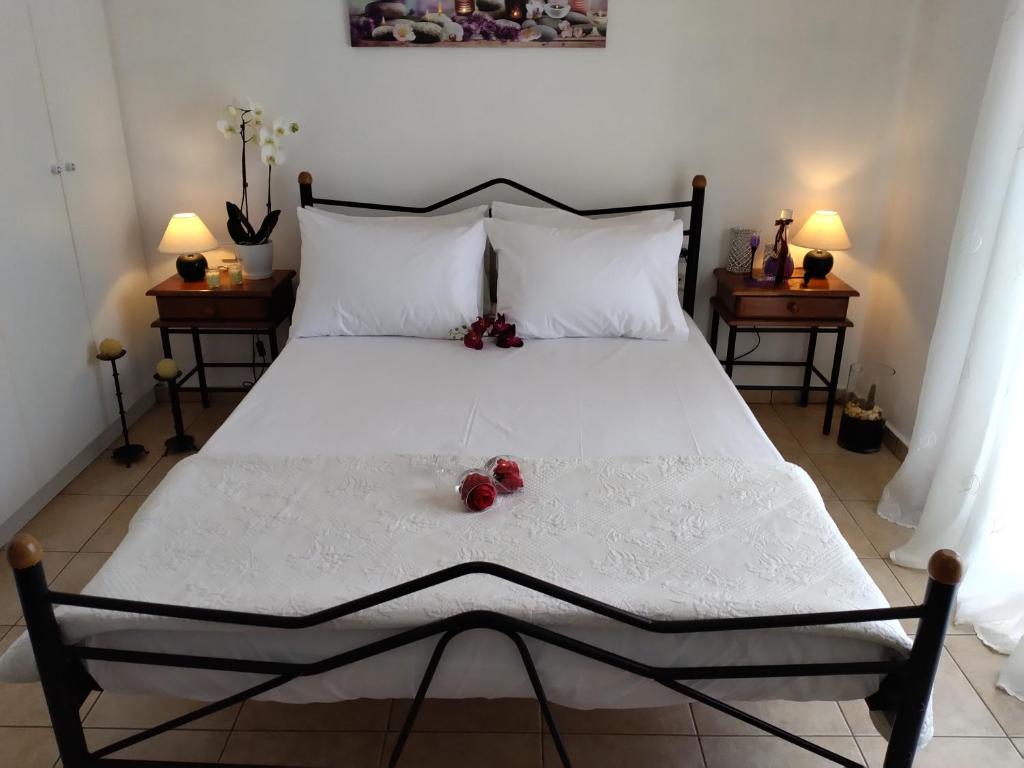 a bedroom with a large white bed with fruit on it at Comfy Alykes Apartment, Volos in Volos