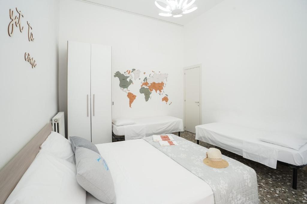 a room with two beds and a world map on the wall at Meraviglia d'Otranto in Otranto