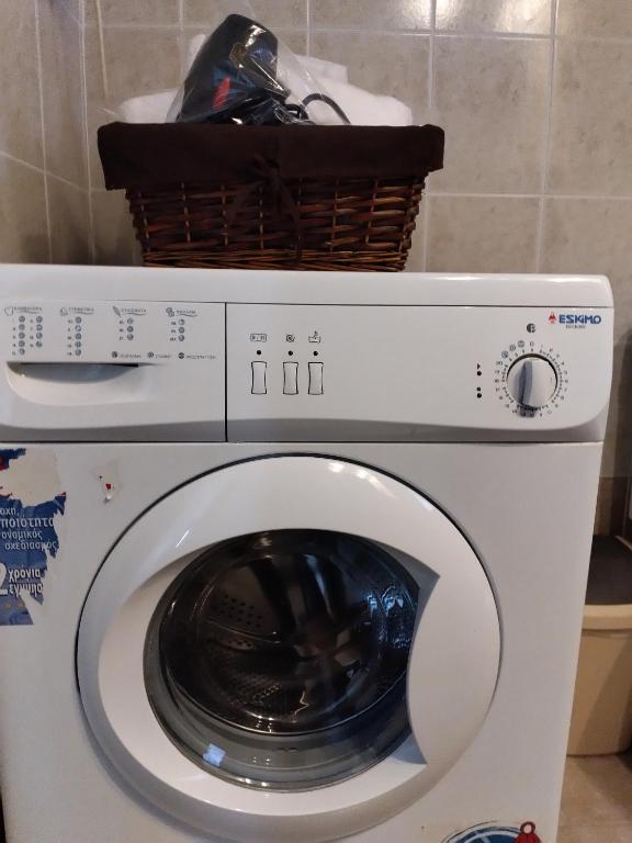 a washing machine with a basket on top of it at Comfy Alykes Apartment, Volos in Volos