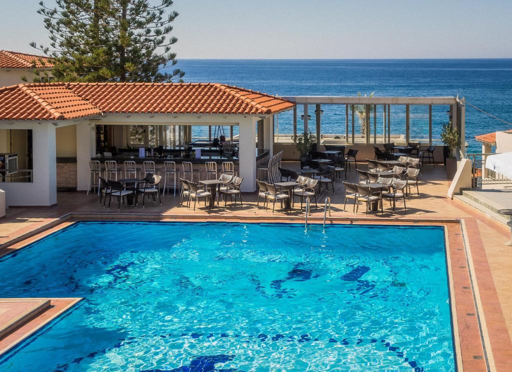 a swimming pool with a view of the ocean at Castello Village Resort in Sissi