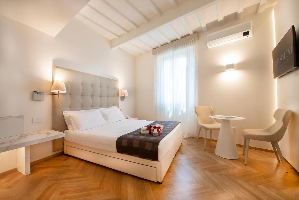 Łóżko lub łóżka w pokoju w obiekcie Asisium Boutique Hotel