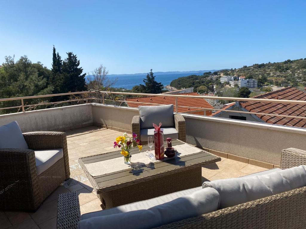 a patio with chairs and a table on a roof at Villa Ecosse in Murter