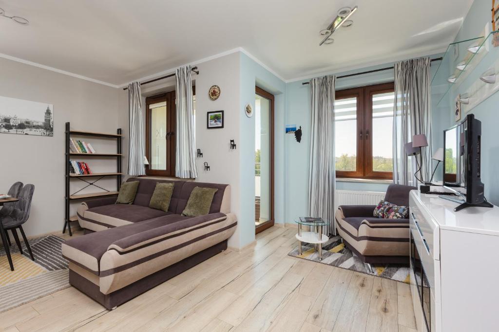 Televízia a/alebo spoločenská miestnosť v ubytovaní Apartment Na Zakolu Wisły by Noclegi Renters