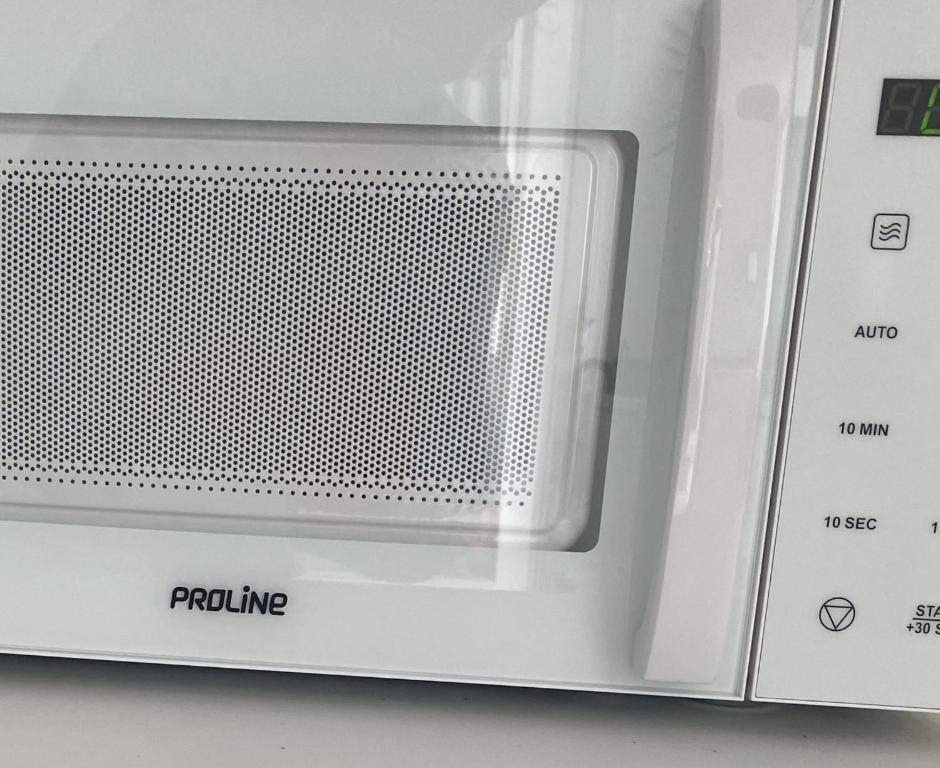 a close up of a white microwave oven at Lou Mut in Lectoure