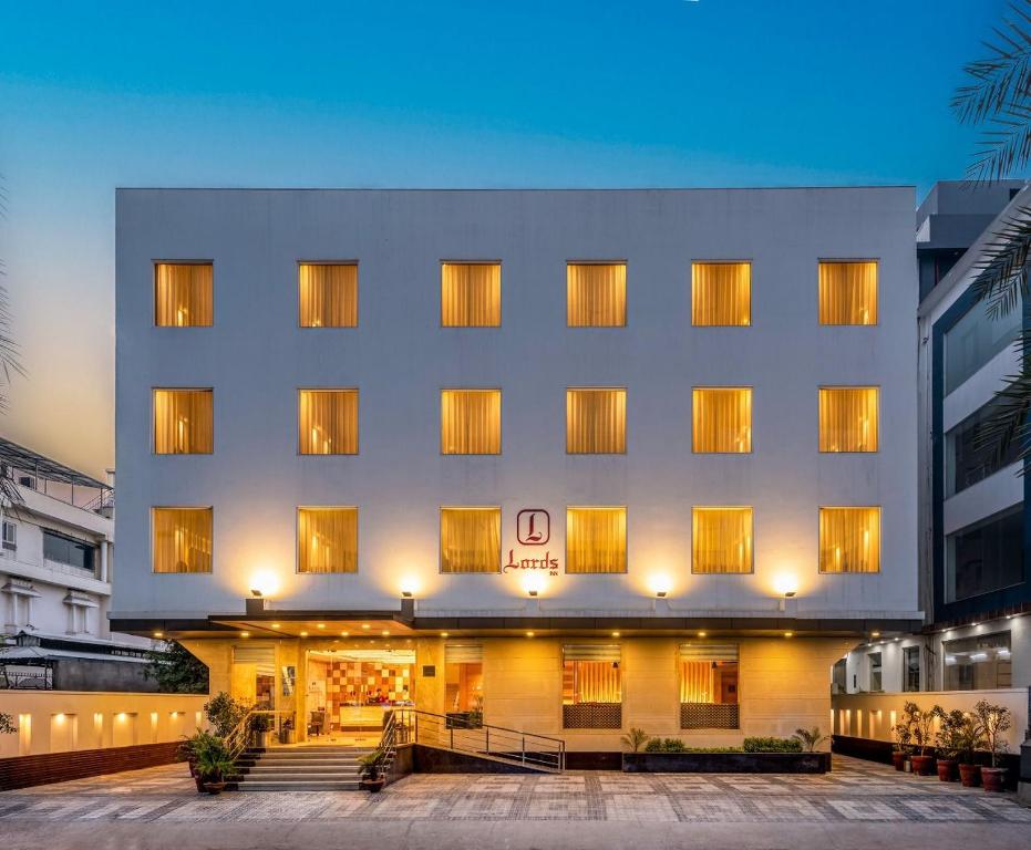 a hotel building with a lit up facade at night at Lords Inn Jaipur in Jaipur