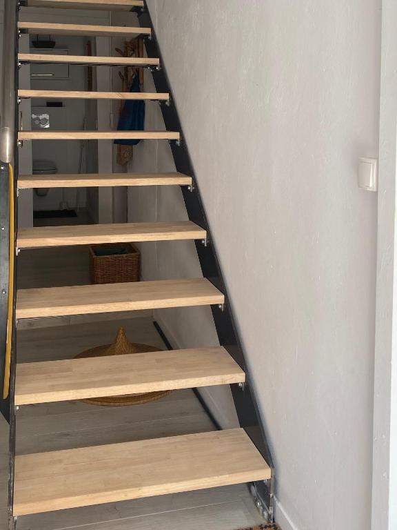 a staircase with wooden shelves in a room at Lou Mut in Lectoure