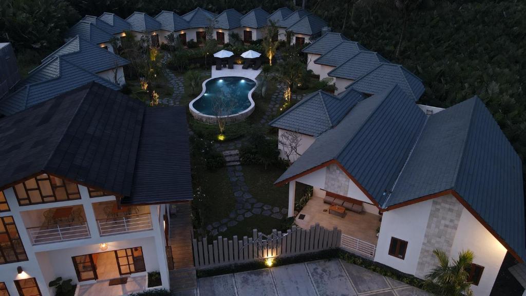 an aerial view of a house with a pool at Artha Cottages in Sidomukti