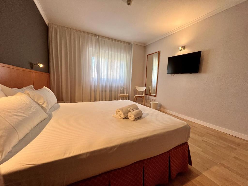 a hotel room with a bed with towels on it at AP Hotel Madrid Airport in Madrid