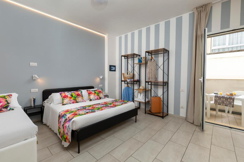 A bed or beds in a room at Rubino Apartments a 100metri dal mare