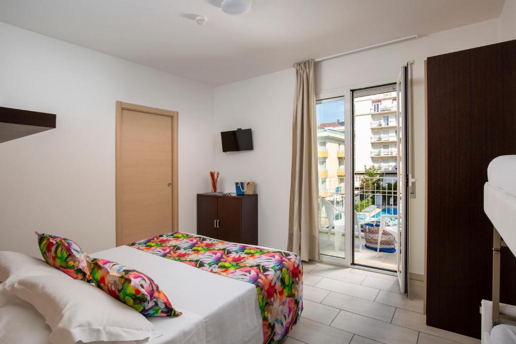 A bed or beds in a room at Rubino Apartments a 100metri dal mare