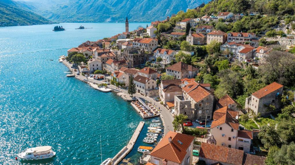 a town on the shore of a body of water at Charming Bohemian house in Perast in Perast