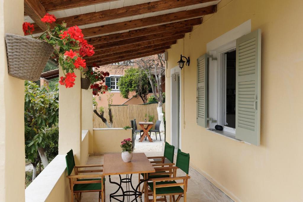 a patio with a table and chairs and flowers at Cottage in the Nature by Konnect, Agios Markos Ipsos in Ágios Márkos