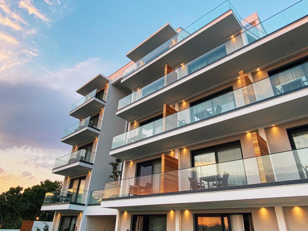 a large building with glass balconies on it at KADAGAN SUİTES AYASARANDA in Çeşme