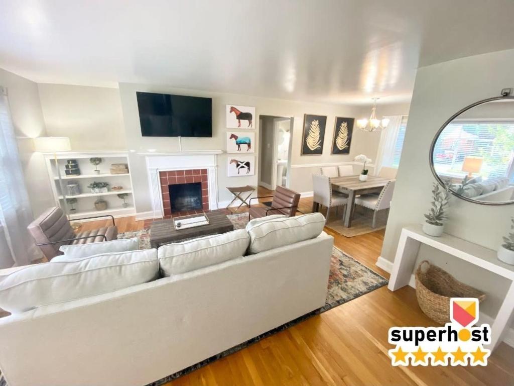 a living room with a white couch and a fireplace at Charming 2 BR 1 BA with outdoor patio and grill close to downtown in Lexington