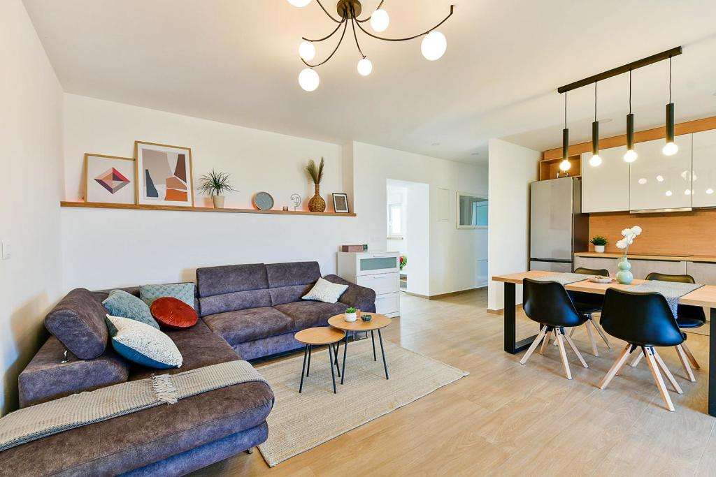 a living room with a couch and a table at Apartment Aura in Poreč