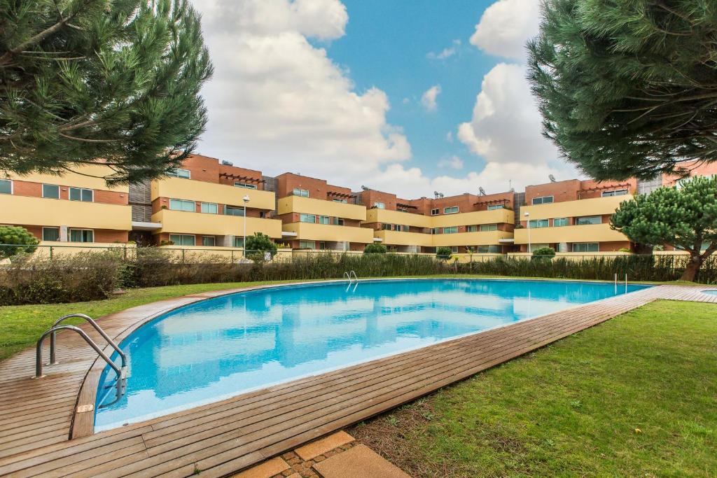 a large swimming pool in front of a building at Furadouro Beach and Club Apartment in Ovar