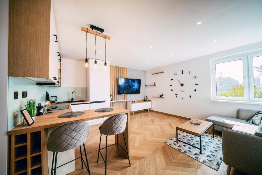 a kitchen and living room with a table and chairs at Luxury Apartment w. City Views in Košice Old Town in Košice