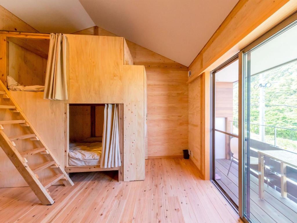 a treehouse with a bunk bed in a room with a large window at Famale Only Dormitory Guest House Amami Long Beach2 Vacation STAY 37994v in Amami