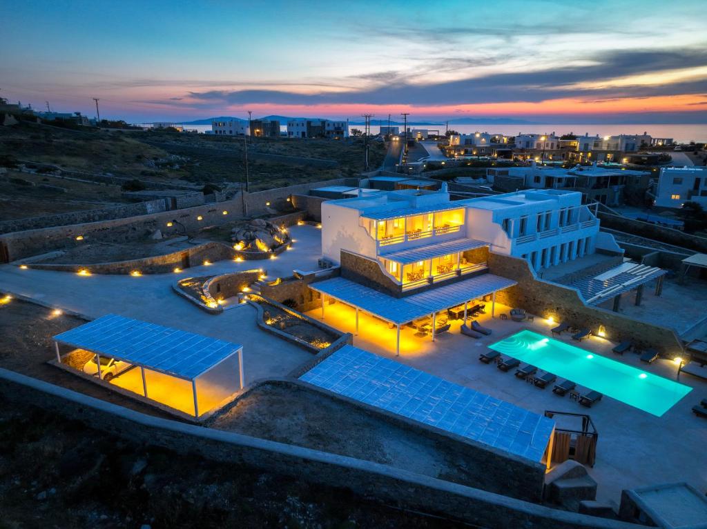 an aerial view of a building with a pool at night at VILLA MAJESTIC CIEL Private beach in Mikonos