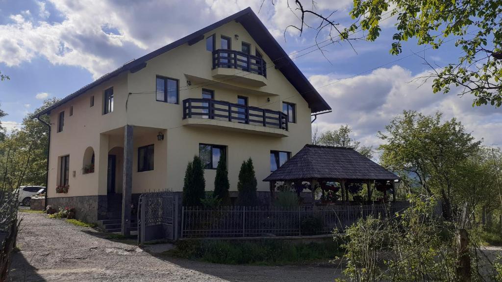 a large white house with a gazebo at Casa Bozai in Breb