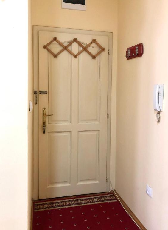 a white door in a room with a red rug at KRAGUJ apartments 1 in Kragujevac