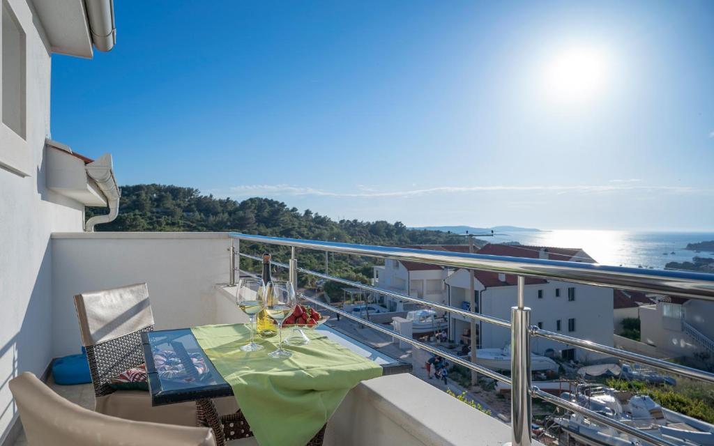 a balcony with a table and a view of the ocean at Villa Fio in Hvar