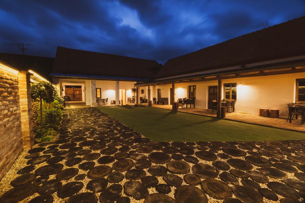 a courtyard of a house with a stone walkway at Penzion Castello in Valtice