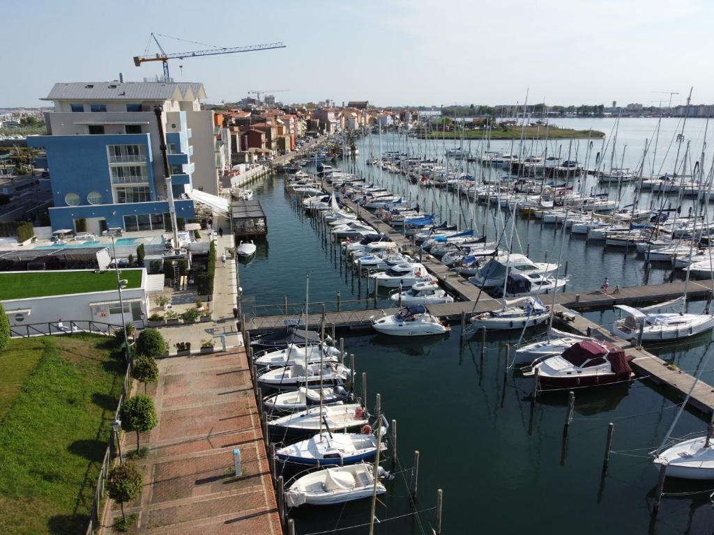 a bunch of boats docked in a marina at Mosella Suite Hotel in Sottomarina