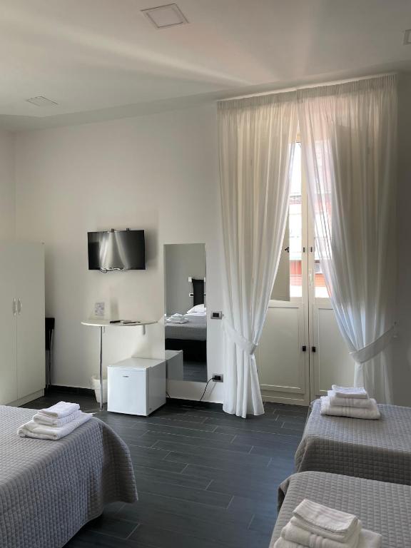 Posteľ alebo postele v izbe v ubytovaní Le Porte di Napoli - Rooms