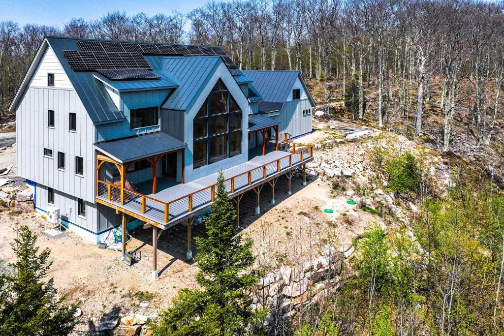 an overhead view of a house with solar panels on it at Franconia Heights Sustainable Mtn Apartment in Franconia
