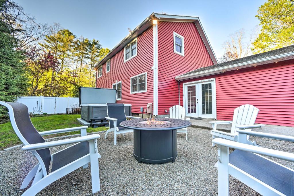 a group of chairs and a table in front of a red building at Family-Friendly Retreat with Hot Tub 1 Mi to Dtwn in Saratoga Springs