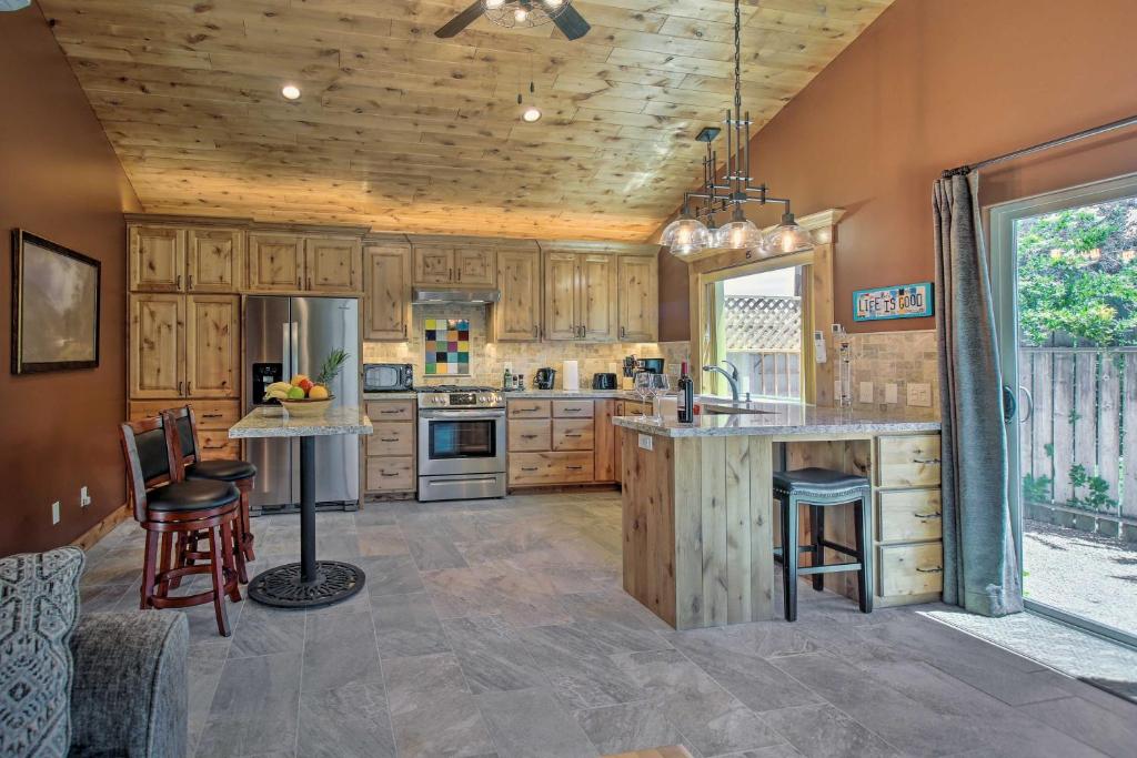 a large kitchen with wooden cabinets and a large island at Twin Palms Romantic Retreat Yard and Grill! in Simi Valley