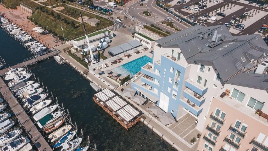 an aerial view of a building next to a marina at Mosella Suite Hotel in Sottomarina