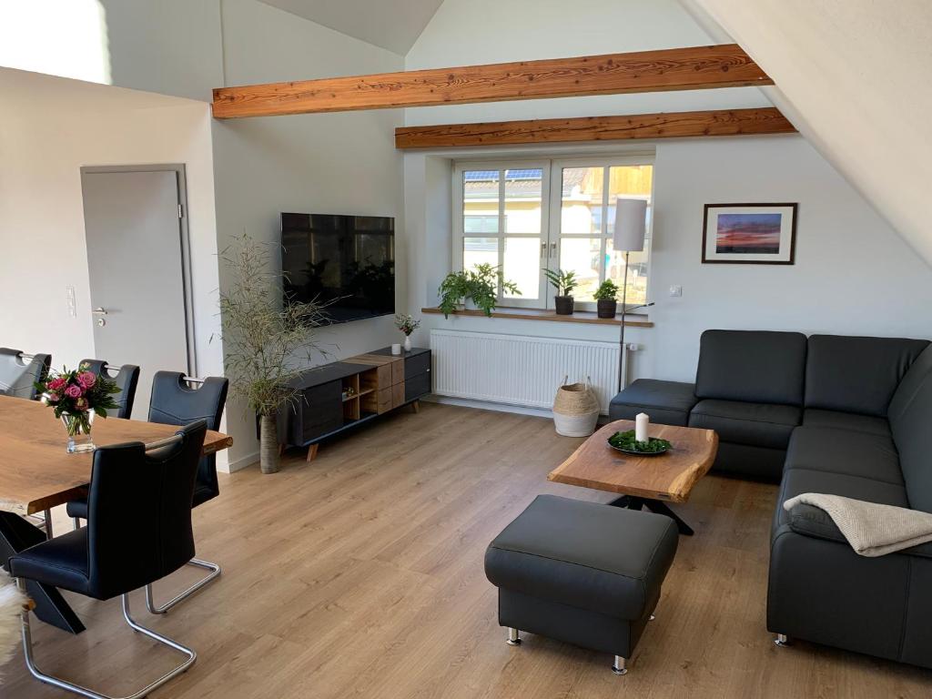 a living room with a couch and a table at Ferienwohung Am Südhang in Bad Bentheim