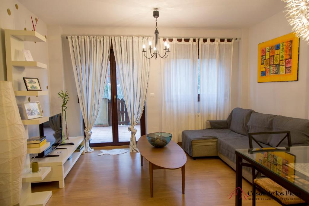 a living room with a couch and a table at Apartamento El Soplao - Casas de los Picos in Celis