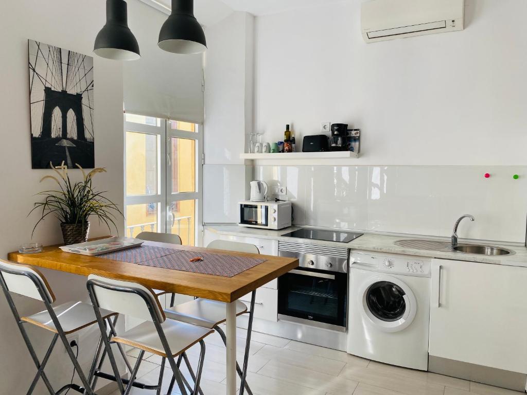 a kitchen with a table and chairs and a sink at Clemens9 Premium in Málaga