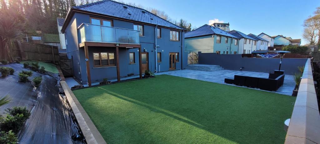 an aerial view of a house with a artificial lawn at Tides Reach - 3 Bedroom Holiday Home - Llanreath in Pembrokeshire