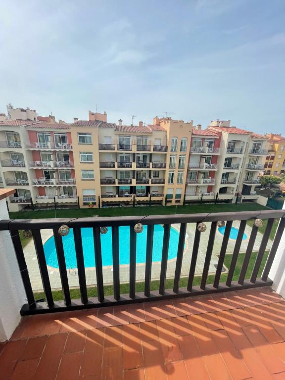 a balcony with a view of some apartment buildings at Appartement Vue Piscine-100 m de la plage in Empuriabrava