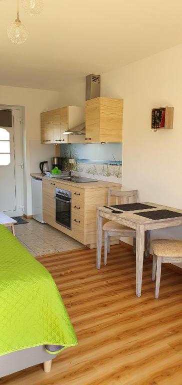 a kitchen with a table and a dining room at Ferienwohnungen Rügen-Glück in Lohme