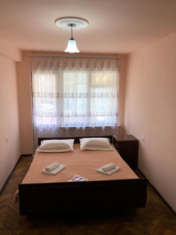 a bedroom with two beds in front of a window at Apartment in Alaverdi in Alaverdi