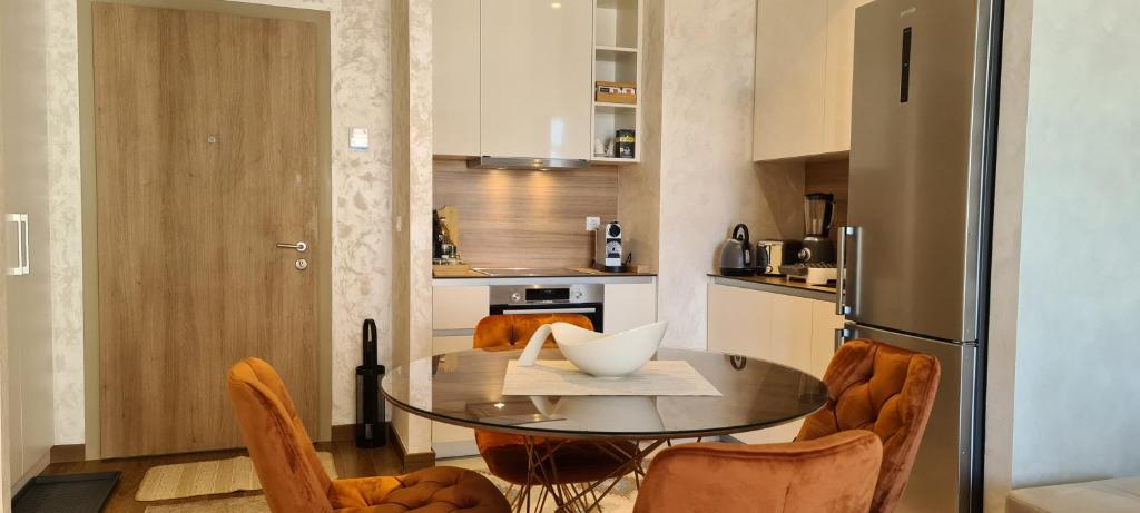 a kitchen with a table and chairs and a refrigerator at Premium NB Apartment - Belgrade Waterfront in Belgrade