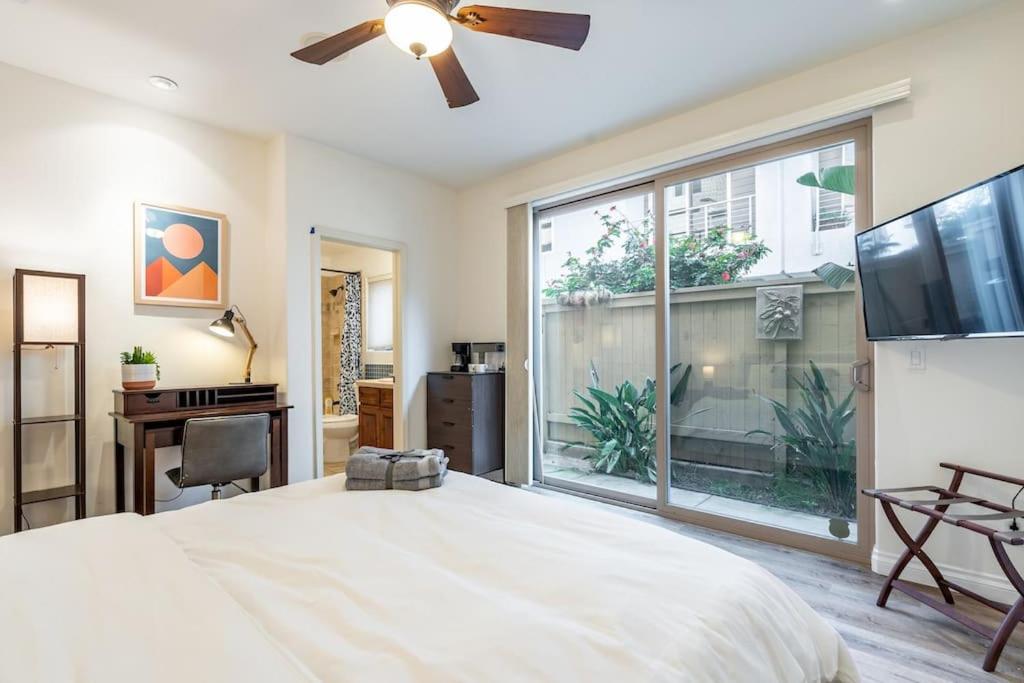 a bedroom with a large bed and a large window at The San Diego Studio - Free Parking in San Diego