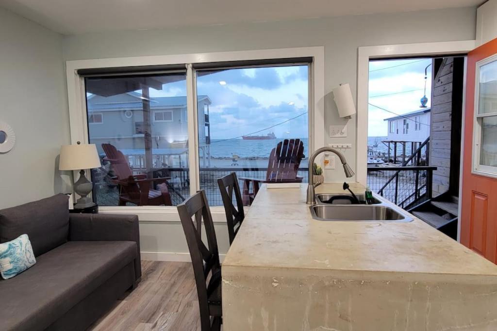 a kitchen with a couch and a table with a view of the ocean at Las Casitas on Magnolia Beach - Casita B in Port Lavaca