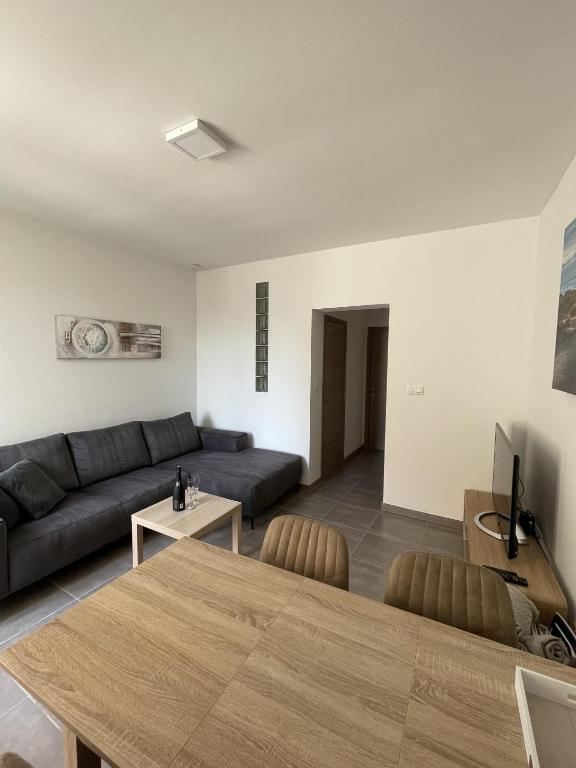 a living room with a couch and a table at Middelbeach in Middelkerke