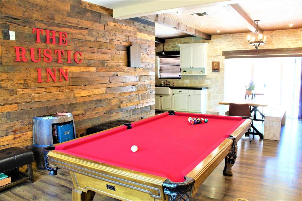 a pool table in a room with a brick wall at The Rustic Inn - Family friendly, Close to Fiesta Texas, SeaWorld, Riverwalk and more in Dominion