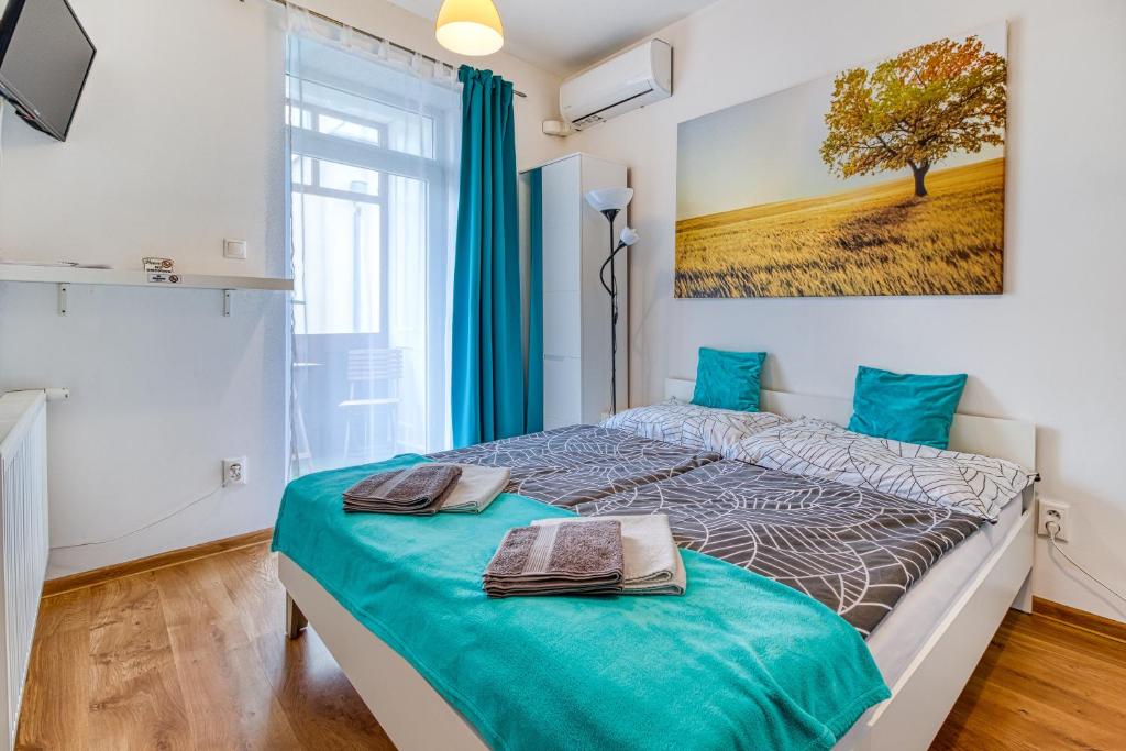 a bedroom with a bed with two towels on it at JonasHouse studios - Great Location near Bratislava City Center in Bratislava