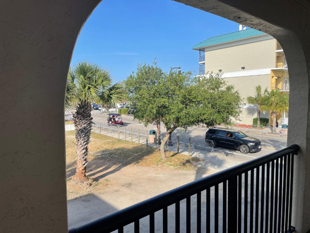 a balcony with a view of a parking lot with a car at Sunburst Hotel in Myrtle Beach