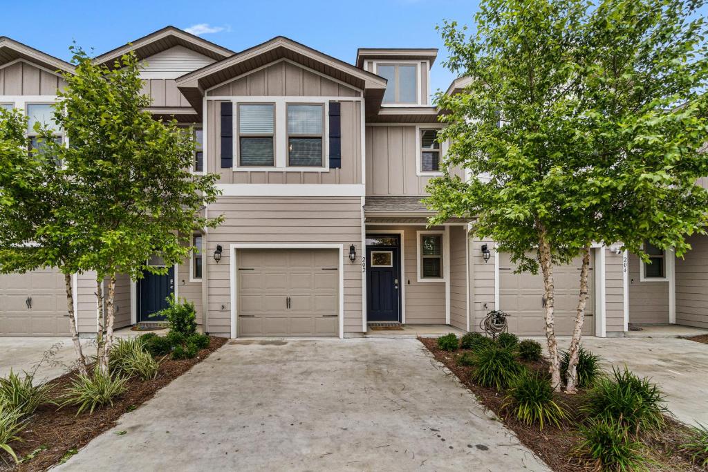 a house with a driveway and trees in front of it at Pensacola Paradise in Pensacola